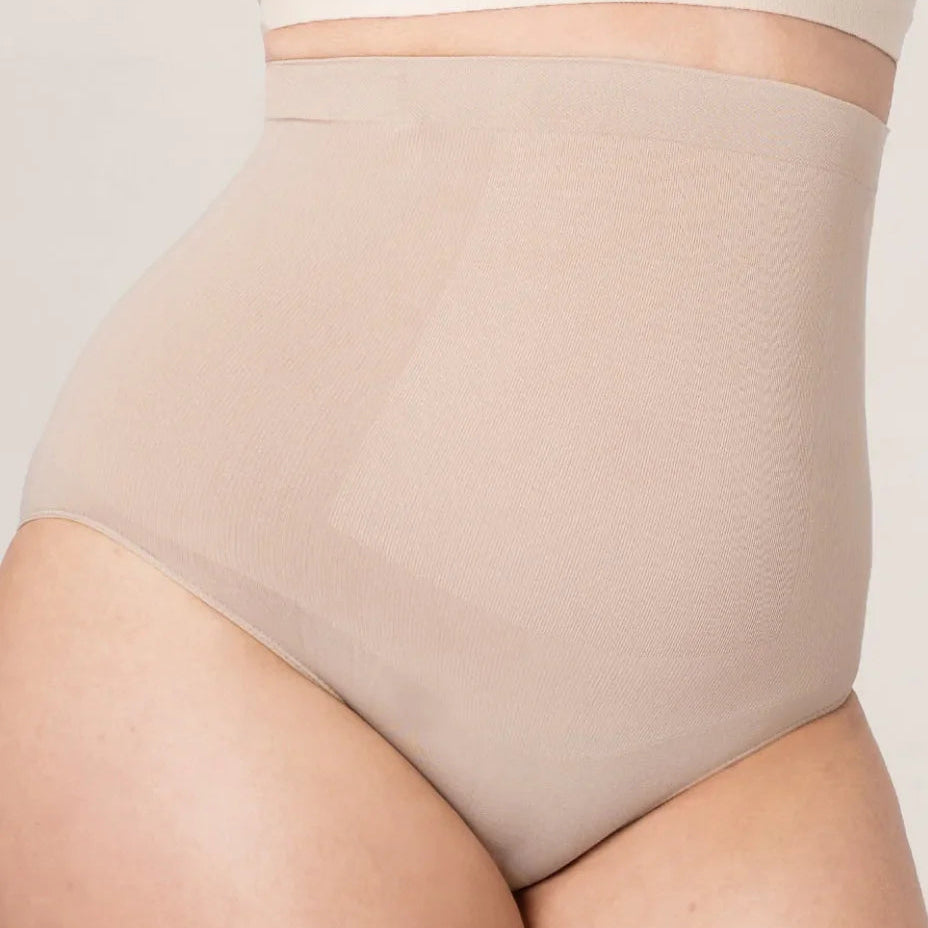 Beige shapewear worn by a person on a light gray background